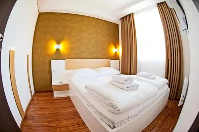 a hotel room with a bed with towels on it at Apartman IRINA 1243 in Kopaonik