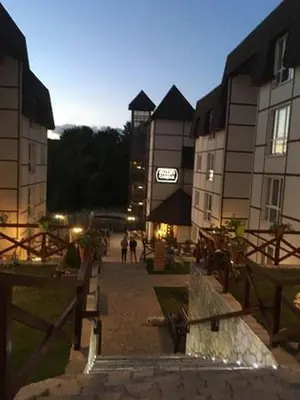 a group of people walking down a street next to buildings at Apartman IRINA 1243 in Kopaonik