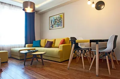 a living room with a yellow couch and a table at Apartman IRINA 1243 in Kopaonik