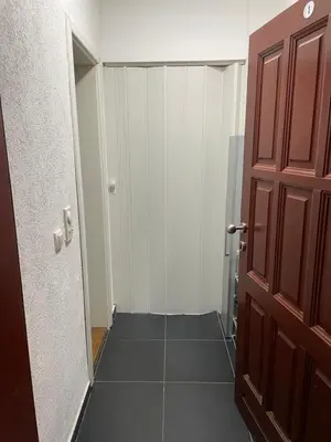 an empty hallway with a door and a tile floor at SUNNY NEST in Vrnjačka Banja