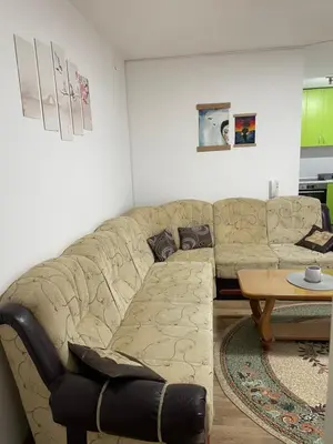 a living room with a couch and a table at SUNNY NEST in Vrnjačka Banja