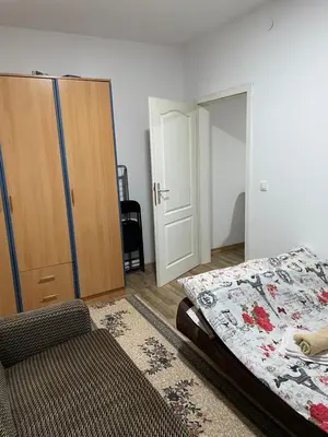 a bedroom with a bed and a closet and a door at SUNNY NEST in Vrnjačka Banja