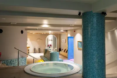 a large bathroom with a tub in the middle of a room at Hotel Sunce in Soko Banja
