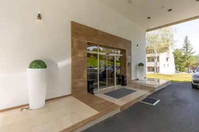 a lobby of a house with a large glass door at Hotel Sunce in Soko Banja