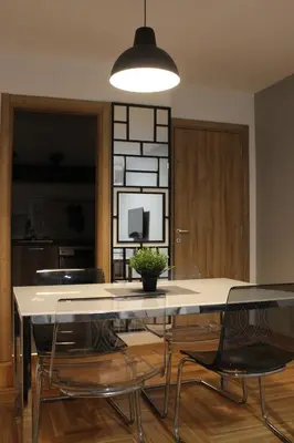a dining room with a large white table and chairs at 3 , 2 , 1 bedrooms , jakuzi and garage parking in Niš