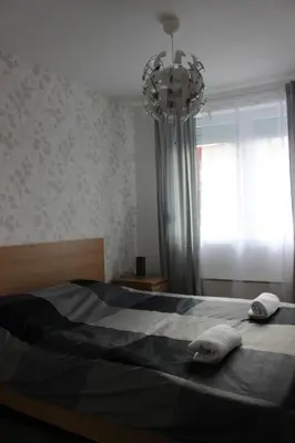 a bedroom with a bed with two towels on it at 3 , 2 , 1 bedrooms , jakuzi and garage parking in Niš