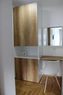 a kitchen with a desk and a white chair at 3 , 2 , 1 bedrooms , jakuzi and garage parking in Niš