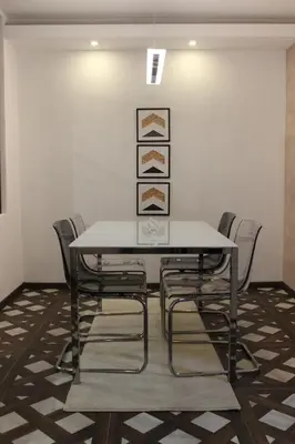 a dining room with a table and chairs at 3 , 2 , 1 bedrooms , jakuzi and garage parking in Niš