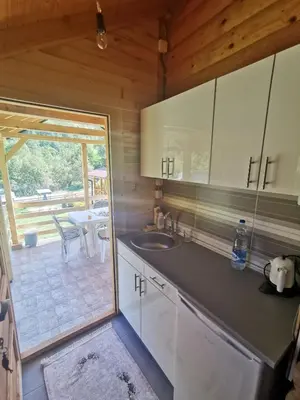 a kitchen with a sink and a view of a patio at Vikendica Mijajlović 2 in Kuršumlija