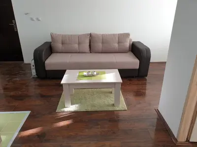 a living room with a couch and a coffee table at Apartman Nota in Kopaonik