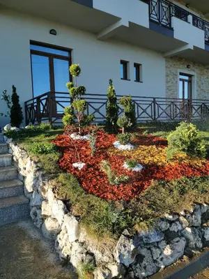 a flower garden in front of a building at Milmari Resort M16 Markovic in Kopaonik