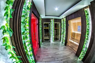 a hallway with red doors and green plants at Milmari Resort M16 Markovic in Kopaonik