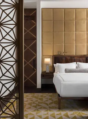 a bedroom with a white bed and a closet at Viceroy Kopaonik Resort & Spa in Kopaonik