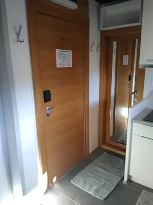 a wooden door in a room with a sign on it at Megi apartman - Konaci Maglic in Kopaonik