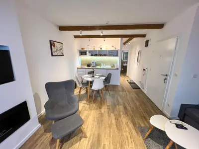a living room with a table and chairs at Apartment A6 Kopaonik in Kopaonik