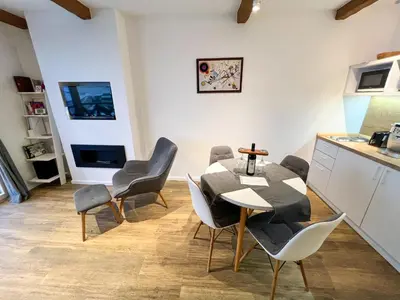 a kitchen and dining room with a table and chairs at Apartment A6 Kopaonik in Kopaonik