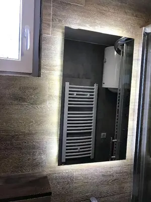 a mirror in a bathroom with a vent at Apartment A6 Kopaonik in Kopaonik