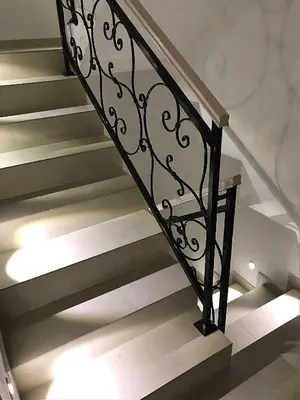 a staircase with a black wrought iron railing at Apartment A6 Kopaonik in Kopaonik