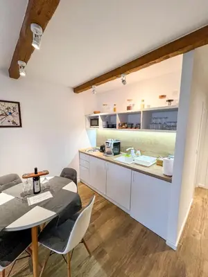 a kitchen and dining room with a table and chairs at Apartment A6 Kopaonik in Kopaonik