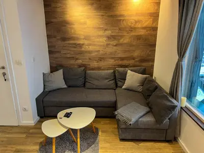 a living room with a couch and a table at Apartment A6 Kopaonik in Kopaonik