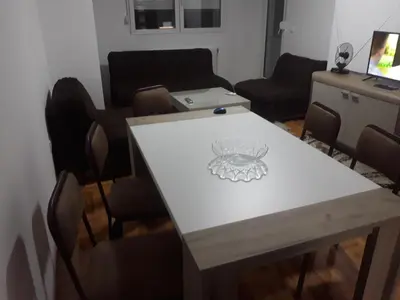 a table with a drawing on it in a living room at Apartman Vranje in Vranje