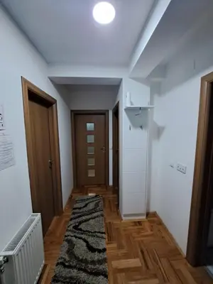 a room with a hallway with a rug and a door at Apartman Vranje in Vranje