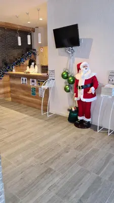 a santa claus standing in a room in a store at Apartman No1,Župa Wellness & Spa Kopaonik in Kopaonik
