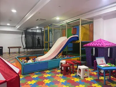 a childrens play room with a slide and a playground at SREBRNA PLANINA Spa & Resort in Kopaonik