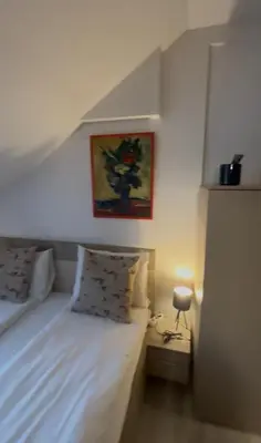a bedroom with a bed and a picture on the wall at Kopaonik Apartmani Milmari - Katic in Kopaonik