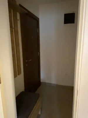 an empty room with a door and a bench in it at Kopaonik Apartmani Milmari - Katic in Kopaonik