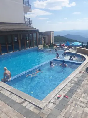 a group of people swimming in a swimming pool at Kopaonik Apartmani Milmari - Katic in Kopaonik