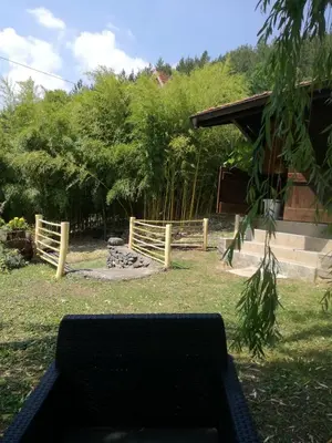 a bench in a yard with a wooden fence at Brvnara Aleksic in Kraljevo