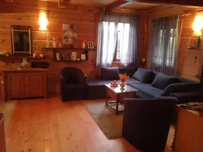 a living room with a blue couch and a table at Brvnara Aleksic in Kraljevo