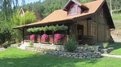 a house with a fence and flowers on it at Brvnara Aleksic in Kraljevo