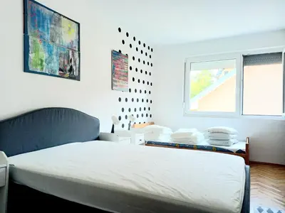 a bedroom with a white bed and a window at Mist8 in Soko Banja