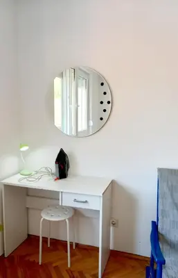 a white desk with a mirror on a white wall at Mist8 in Soko Banja