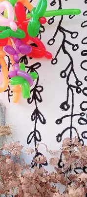 a birthday cake with black frosting and balloons on it at Mist8 in Soko Banja