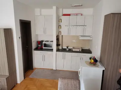 a kitchen with white cabinets and a counter top at Apartman Dream,Kraljevi Čardaci, sa besplatnim parkingom u garazi in Kopaonik
