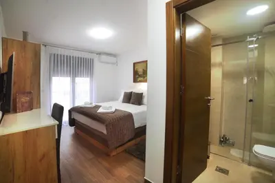 a bedroom with a bed and a bathroom with a shower at 