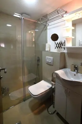 a bathroom with a shower and a toilet and a sink at 