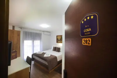 a hotel room with a bed and a sign on the door at 