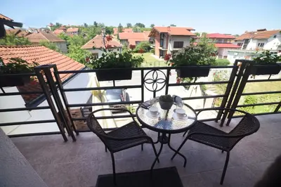 a table and chairs on a balcony with a view at 