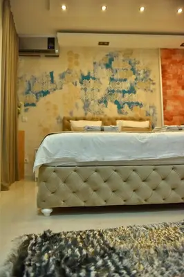 a large bed in a room with a wall at Design Apartment PREMIUM SPA LUX 4 STAR 