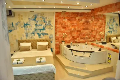 a room with two beds and a bath tub at Design Apartment PREMIUM SPA LUX 4 STAR 