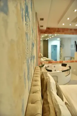 a room with a couch against a wall at Design Apartment PREMIUM SPA LUX 4 STAR 