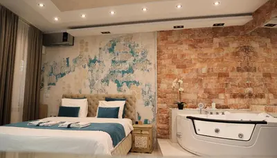 a bedroom with a bed and a bath tub at Design Apartment PREMIUM SPA LUX 4 STAR 