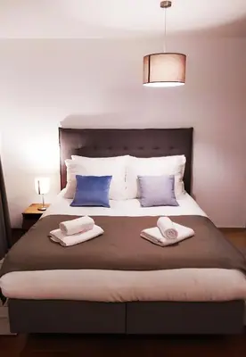 a bedroom with a bed with two towels on it at Apartman Paradiso 211 in Vrnjačka Banja