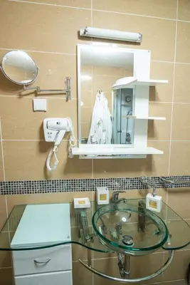 a bathroom with a glass sink and a mirror at Apartman Paradiso 211 in Vrnjačka Banja
