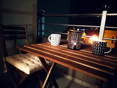 a wooden table with two mugs and a fireplace at Apartman Paradiso 211 in Vrnjačka Banja