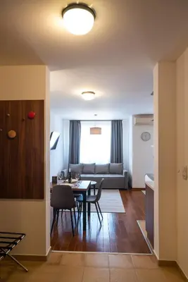 a living room with a table and a couch at Apartman Paradiso 211 in Vrnjačka Banja